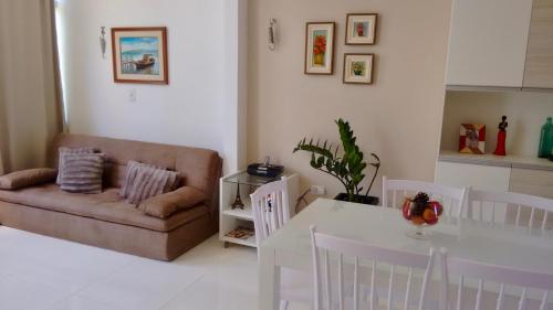 a living room with a couch and a table at Residencial Madakaru - Chalé 14 in Porto De Galinhas