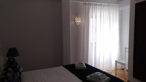 a bedroom with a bed in front of a window at Route 2 Torrão in Torrão