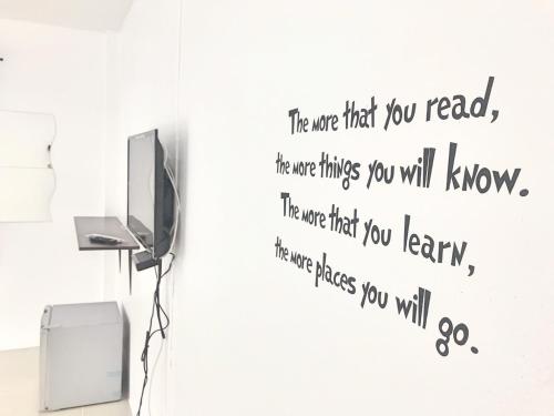 a wall sticker in a room with a tv at Rest Point Sampran in Nakhon Pathom