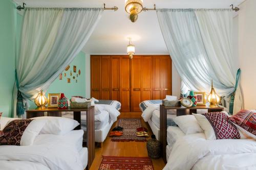 a living room with white couches and curtains at Kashikiri Ikkenya YUME in Osaka