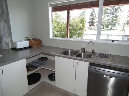 a kitchen with a sink and a window at 46 MacKenzie in Twizel