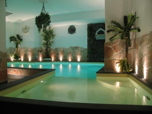 a swimming pool with lights and plants in a room at Hotel Due Mari in Sestri Levante