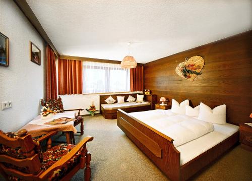 una camera da letto con un letto e un divano in una stanza di Gästehaus Mrak a Längenfeld