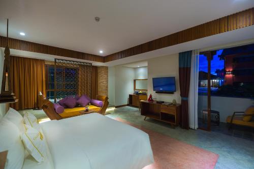 a bedroom with a large bed and a television at Golden Temple Boutique in Siem Reap