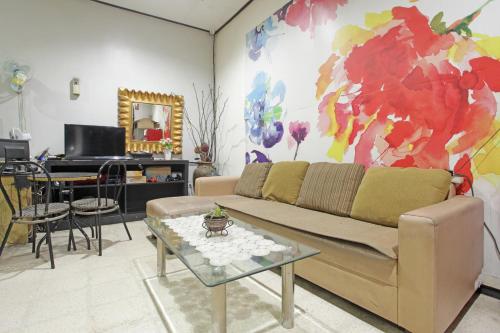a living room with a couch and a table at RedDoorz @ Soekarno Hatta 2 in Malang