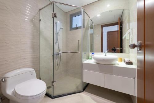 a bathroom with a shower and a toilet and a sink at Park Hill No1 Apartment in Hanoi