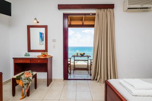 a room with a door leading to the ocean at Ammos Residence in Minia