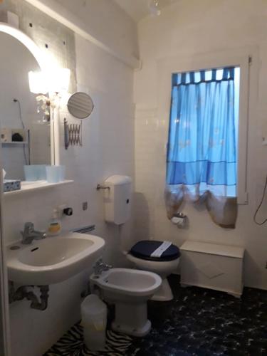 a bathroom with a sink and a toilet and a window at Cà Del Giazzo in Venice