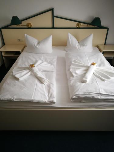 two white pillows on a bed in a room at Hotel 3 Linden in Leipzig