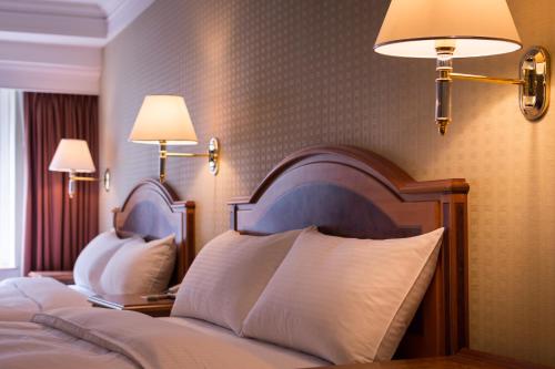 a hotel room with two beds and two lamps at Green World Flora Annex in Taipei