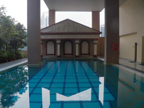a swimming pool with a gazebo in a building at Maytower Apartment in Kuala Lumpur