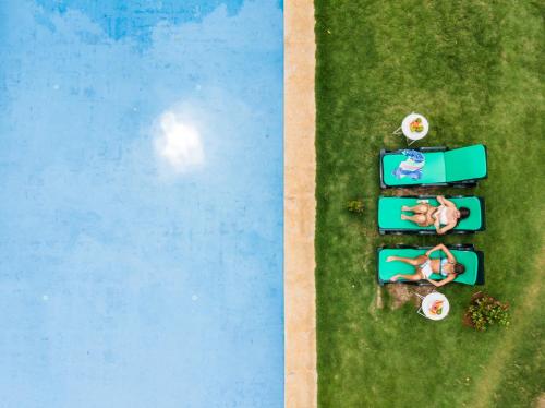 an overhead view of a pool with people on the grass at Roça Santo António Ecolodge in São Tomé