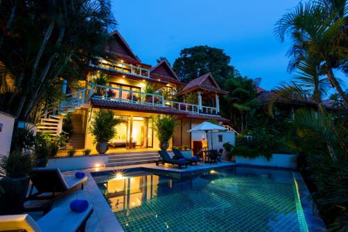 a house with a swimming pool in front of it at Katamanda Kata View villa E5 near kata Noi Beach in Kata Beach