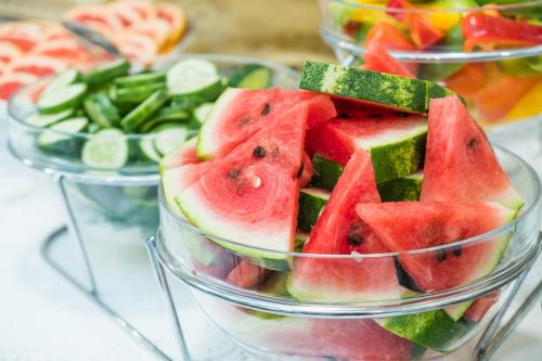 a group of three bowls filled with watermelon and vegetables at Hotel Bologna in Prague