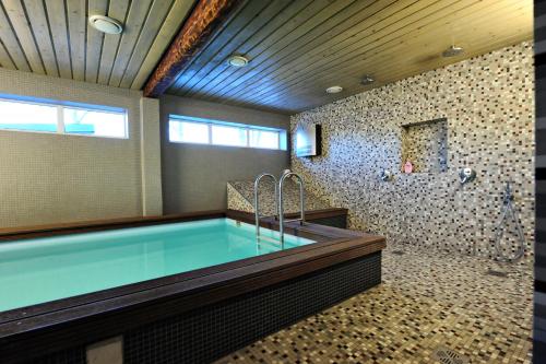 a large bathroom with a tub and a shower at Sadama street Villa in Pärnu
