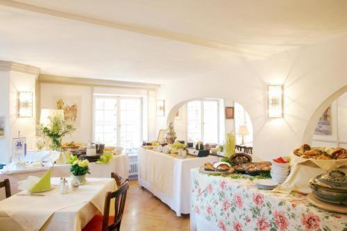 una grande stanza con due tavoli con sopra del cibo di Hotel Weisses Ross a Dinkelsbühl