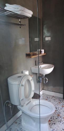 a bathroom with a toilet and a sink at Carambola Bungalow in Phong Nha