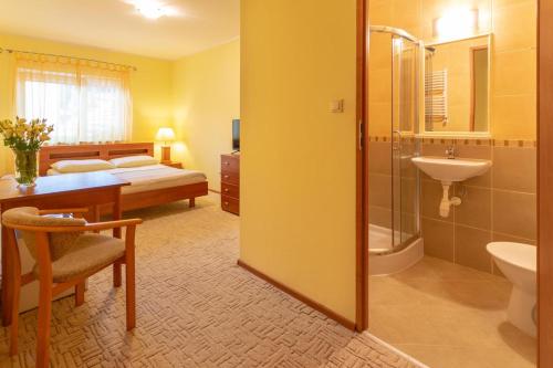 ダルウフコにあるPensjonat Marynarski - Apartamentyのバスルーム(シャワー、シンク、ベッド付)