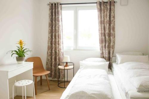 a small bedroom with a bed and a window at Ferienwohnung "Zansibar Tansania" in Uhldingen-Mühlhofen