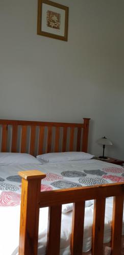 a bedroom with a bed with a wooden table at The Eastern Hotel Accommodation in Ballarat