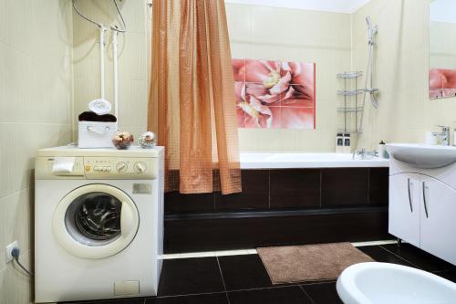 y baño con lavadora y lavamanos. en PaulMarie Apartments on Lenina Avenue, en Gomel