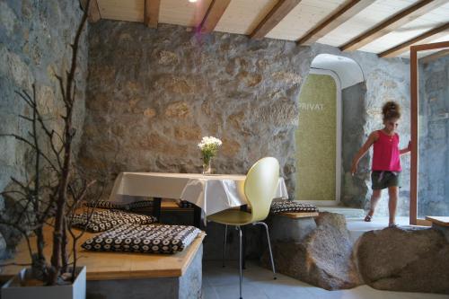 a young child standing in a room with a table at Gotthard Backpacker in Wassen