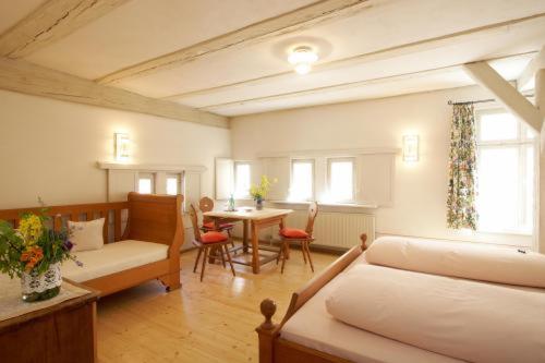 a living room with a couch and a table at Hotel Weisses Ross in Dinkelsbühl