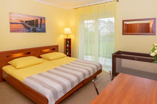 Postel nebo postele na pokoji v ubytování Pensjonat Marynarski - Apartamenty