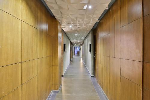 a hallway with wood walls and a long hallway with a hallway at Keys Select by Lemon Tree Hotels, Gandhi Ashram, Ahmedabad in Ahmedabad