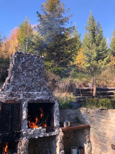 a stone oven with a fire inside of it at RIVIERA in Lekechi