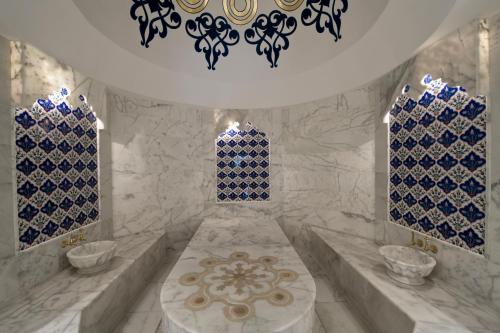 a bathroom with blue and white tiles on the wall at Maxx Royal Belek Golf Resort in Belek