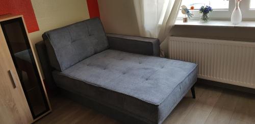 a gray chair in a room with a window at Nicky in Emden