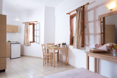 a kitchen with a baby sleeping in a basket on the counter at Anna Maria in Malia