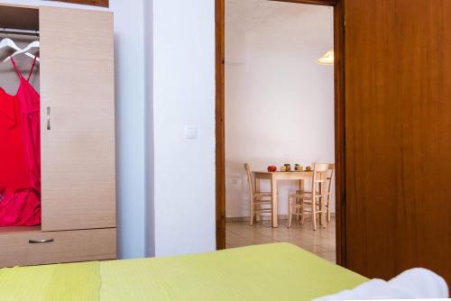 a room with a closet and a dining room with a table at Anna Maria in Malia