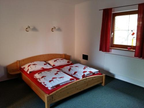 a bedroom with a bed with four pillows on it at Pension U Stříbrného Jelena in Cheb