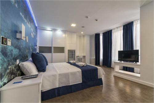 a bedroom with a large bed and a television at Hotel Ciudad del Mar in Las Palmas de Gran Canaria
