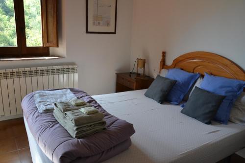 a bedroom with a bed with towels on it at Mas Franch in San Miguel de la Pineda
