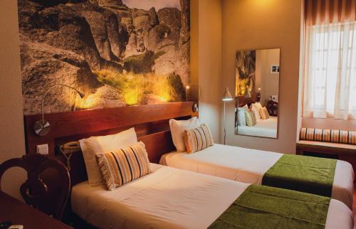 Ένα ή περισσότερα κρεβάτια σε δωμάτιο στο Hotel Império do Rei