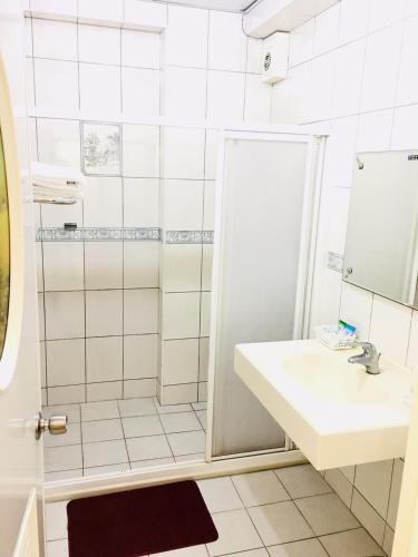 a bathroom with a sink and a shower at Sun Moon Beauty in Yuchi