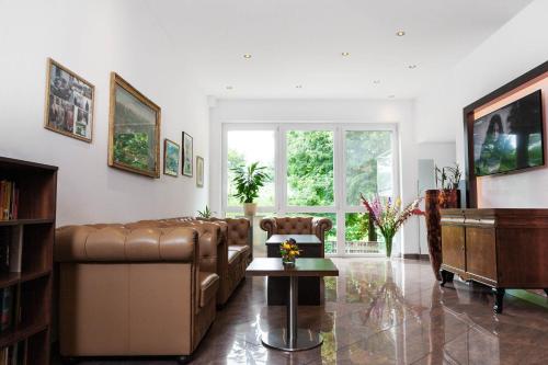 a living room with a couch and a table at Hotel Plattenwirt in Klagenfurt