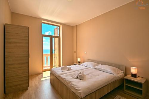 מיטה או מיטות בחדר ב-Rotonda Inn Novigrad