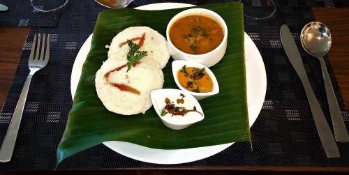 a plate of food on a banana leaf at WelcomHeritage Ashdale in Nainital