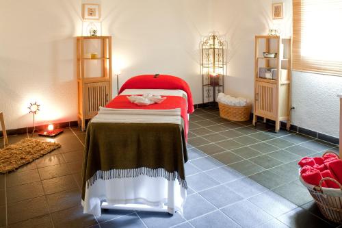 a bedroom with a bed with a red blanket on it at Résidence Orelle 3 vallées by Resid&Co in Orelle