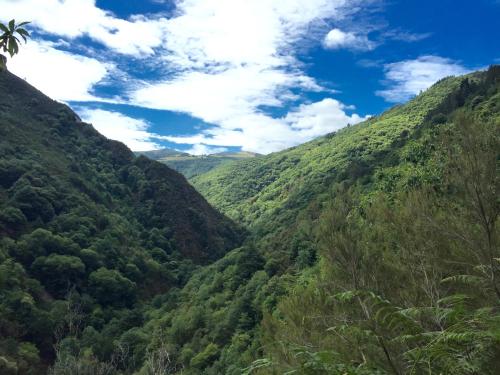 a view from the moanalua middle ridge of a green valley at Aldea Rural y Gastro Restaurante Casona de Labrada in Labrada