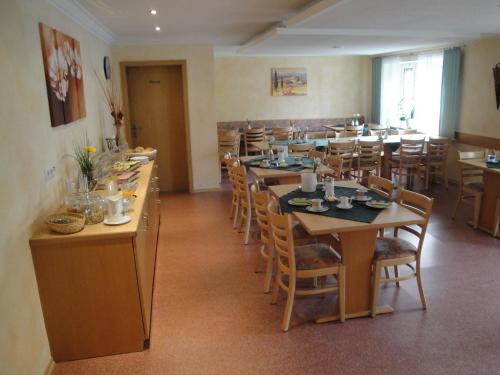 a large dining room with tables and chairs at Gasthof zum Ochsen in Waldstetten