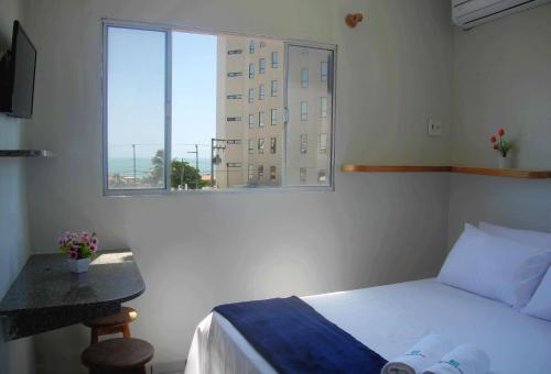 Postel nebo postele na pokoji v ubytování Flat Pousada da Praia