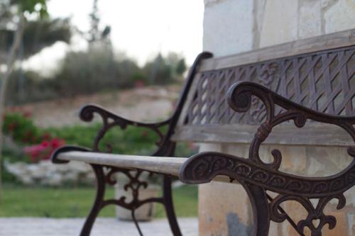a wooden bench sitting next to a building at Kritamos Villa & Apartments in Kamilari
