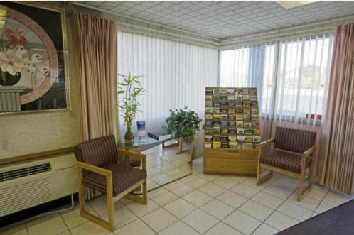 a living room with two chairs and a table at Executive Inn in Fort Wayne