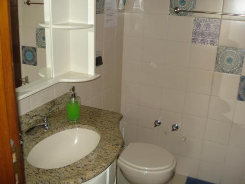 a bathroom with a sink and a toilet at Ótimo Apto Shopping Iguatemi in Porto Alegre