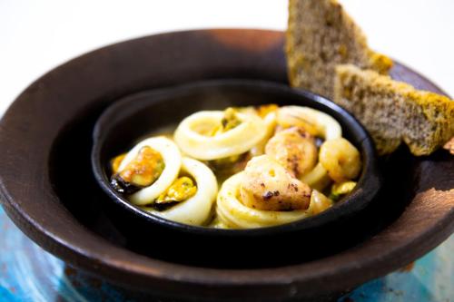 a bowl of food with some food in it at Weskar Lodge Hotel in Puerto Natales